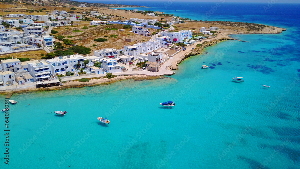 Aerial drone photo of iconic port of Koufonissi beach with docked fishing boats and turquoise waters, Koufonissi island, small Cyclades, Aegean, Greece