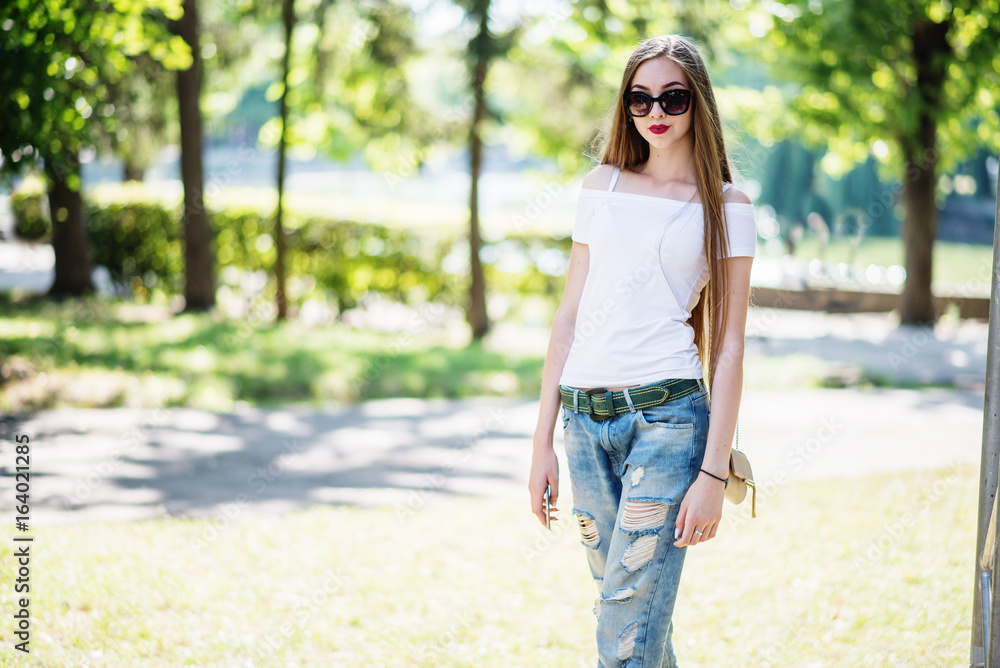 Close-up portrait of a fantastic young model girl posing in the park on a sunny day. Close-up portrait of a fantastic young model girl posing in the park on a sunny day.