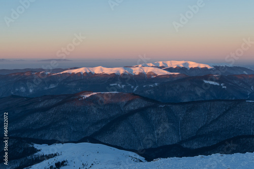 scenic sunrise, above the winter mountains. mountain range