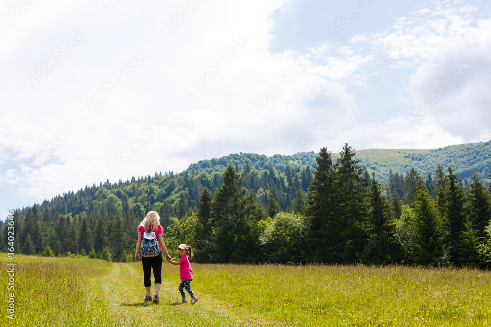 mother and little daugther hiking in mountains mother and little daugther hiking in mountains