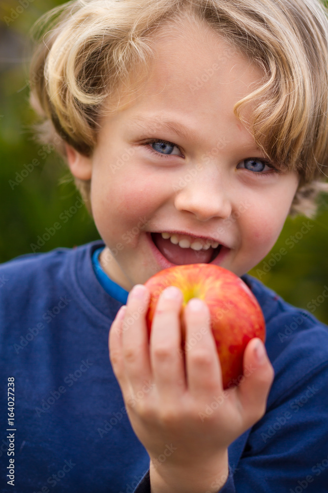 cute 5 year old child eating an apple cute 5 year old child eating an apple