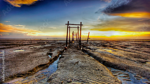 The majestic sunset captured at Pantai Jeram, Selangor, Malaysia during a low tide sea water level. 