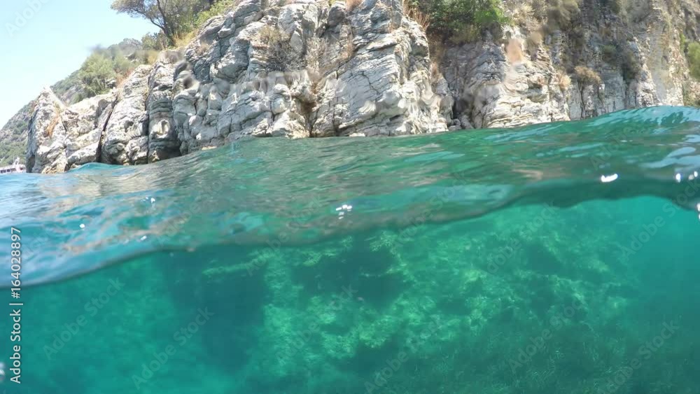 Half underwater close up, backgound split by waterline, Turkey, Mediterranean Sea Half underwater close up, backgound split by waterline, Turkey, Mediterranean Sea