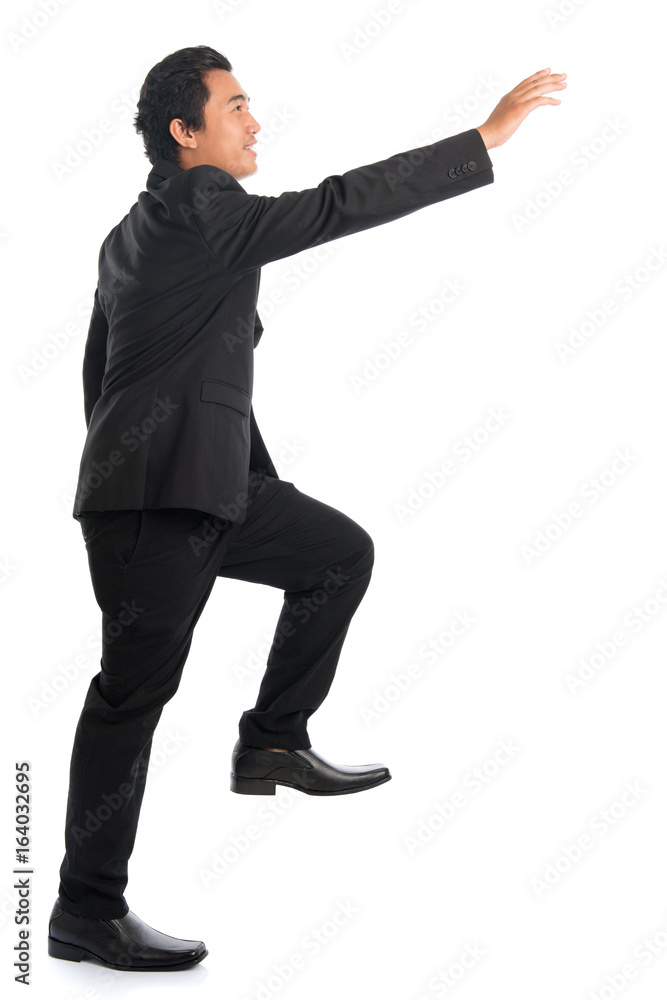Full body Asian businessman hand reaching high Full body Asian businessman hand reaching high