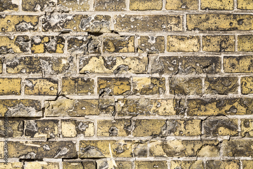 old grungy yellow brick wall for backgrounds