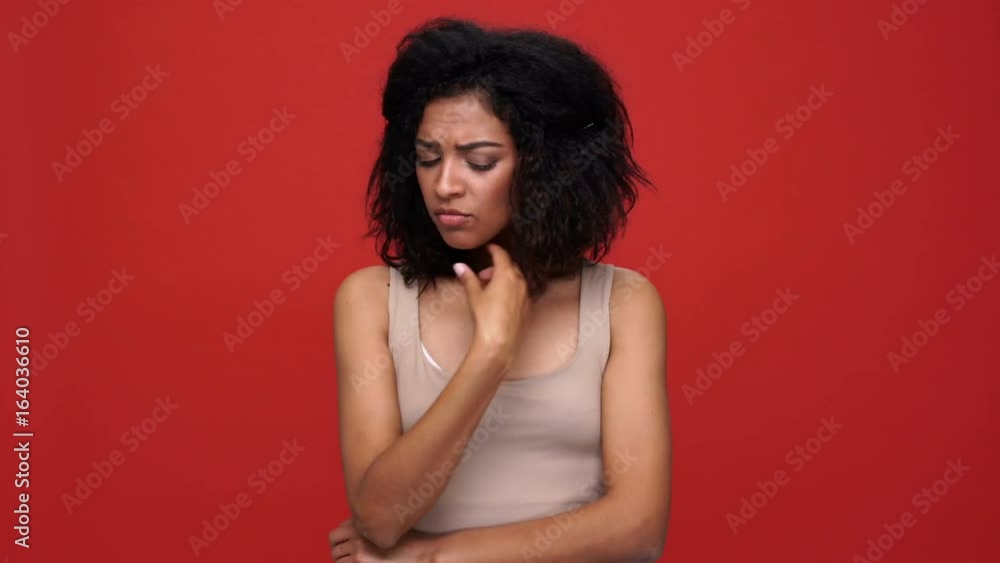 Young african woman showing different emotions over red background Young african woman showing different emotions over red background