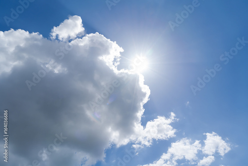cloudscape with blue sky and sun for backgrounds