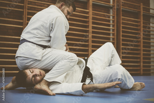 Two young males practicing judo together. © liderina