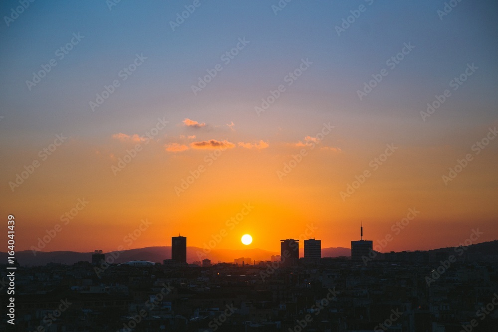 Sun setting over city