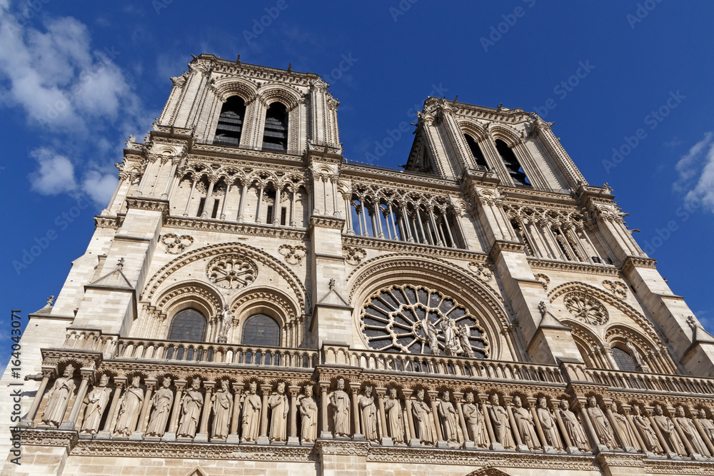 close up of Notre-Dame de Paris cathedral against blue sky