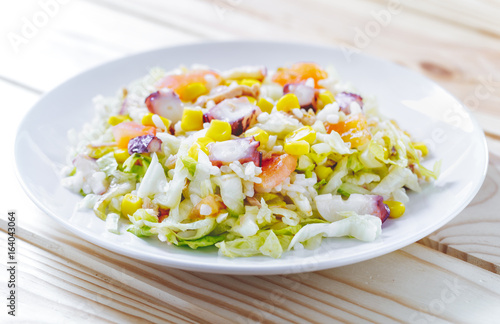 Cold summer salad with rice, coctopus, corn and vegetables. Concept of healthy food.