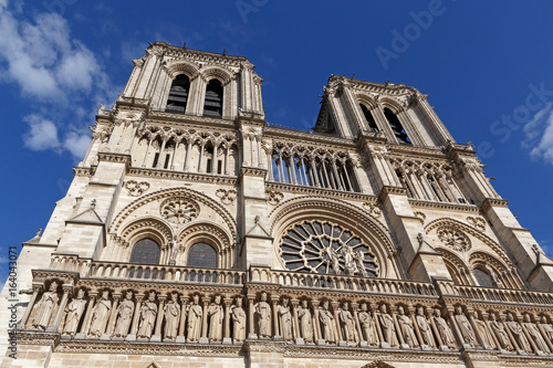 close up of Notre-Dame de Paris cathedral against blue sky