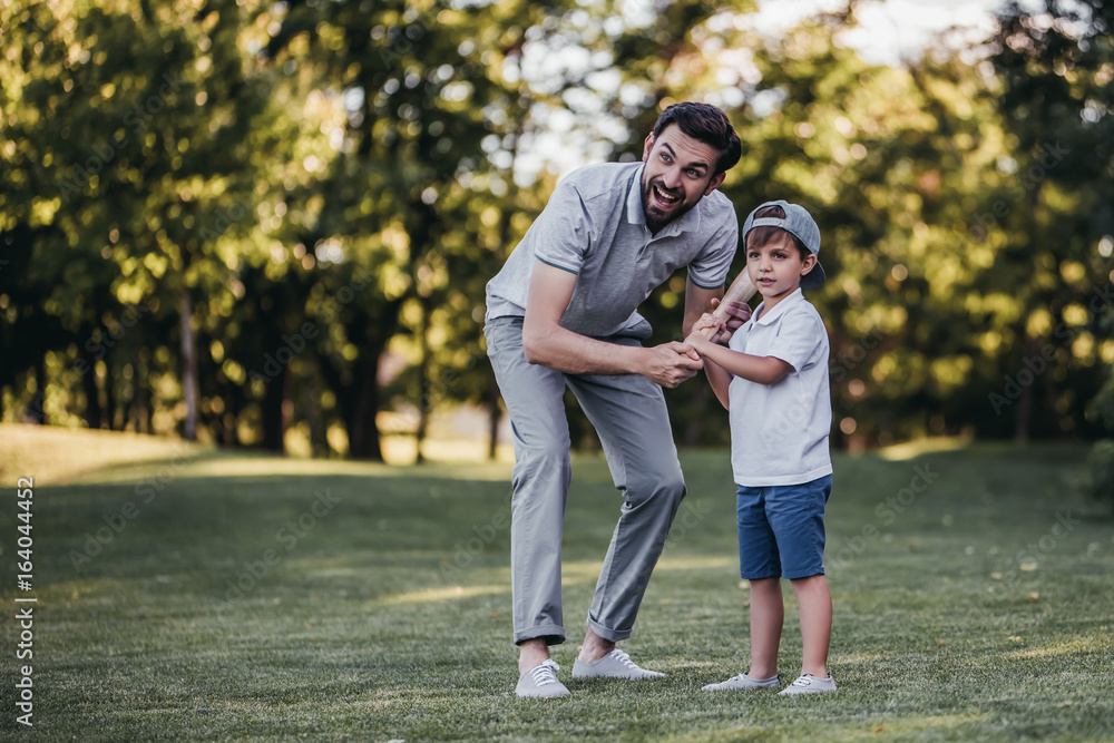 Dad with son playing baseball