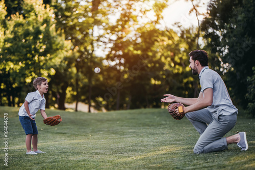 Dad with son playing baseball
