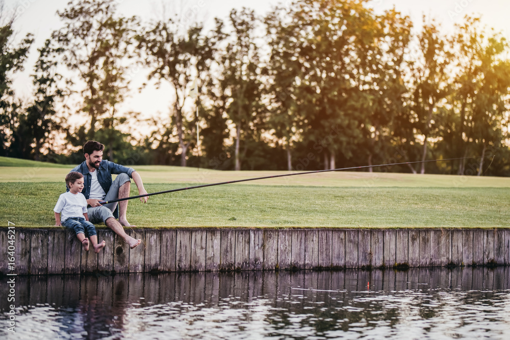 Dad and son are fishing Dad and son are fishing