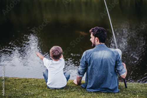 Dad and son are fishing