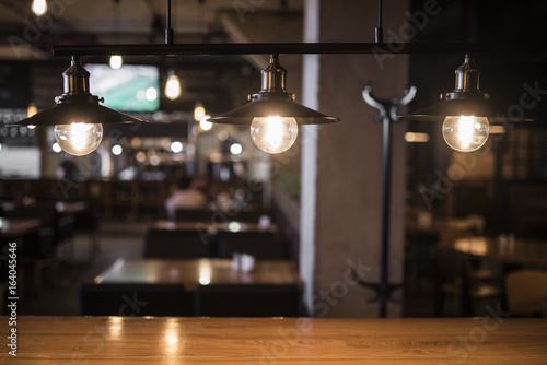 Vintage lamps over a wooden table in a bar 2