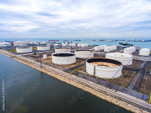 Aerial view Oil refinery with a background of the sea and sky.The factory is located in the middle of nature and no emissions. The area around the air pure.business logistic.