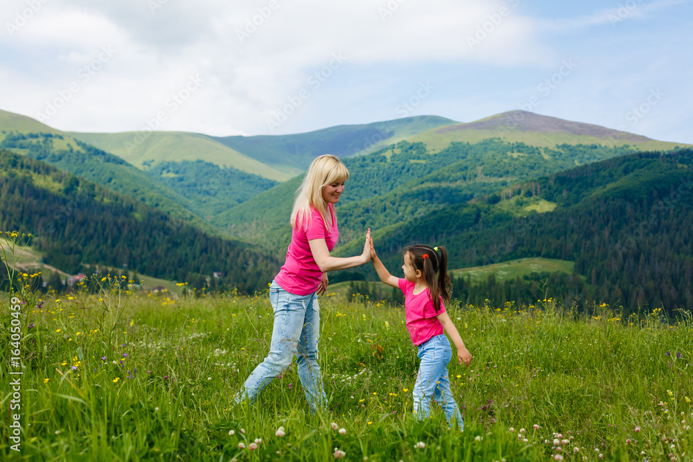 Fototapeta premium Beautiful mother and daughter on the mountain