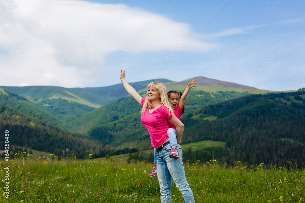Beautiful mother and daughter on the mountain Beautiful mother and daughter on the mountain