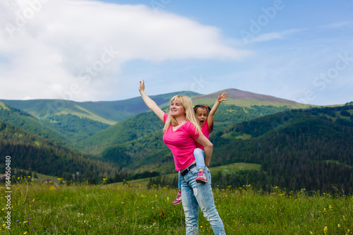 Beautiful mother and daughter on the mountain