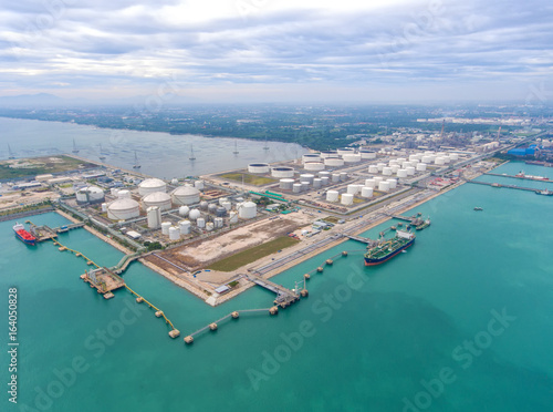 Aerial view Oil refinery with a background of the sea and sky.The factory is located in the middle of nature and no emissions. The area around the air pure.business logistic. © MAGNIFIER