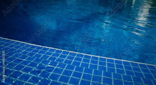 Clean blue water of the swimming pool, nobody. Swimming pool background.