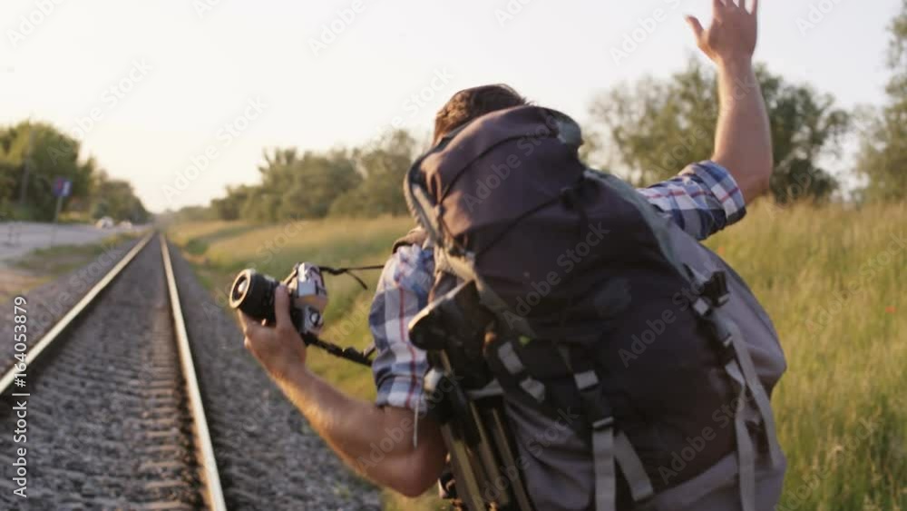 Young Man Trying to Keep the Balance on Railway Tracks Young Man Trying to Keep the Balance on Railway Tracks
