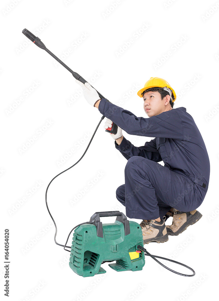 Young man sitting and holding high pressure water gun Young man sitting and holding high pressure water gun