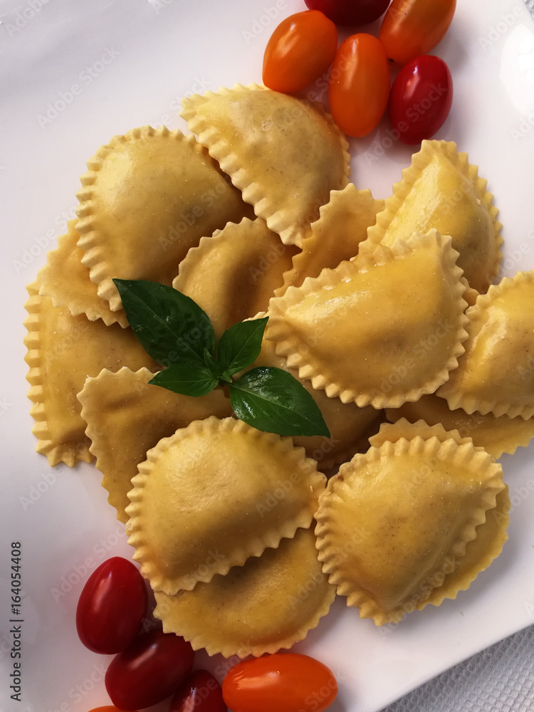 Italian pasta, ravioli, with basil and tomatoes Italian pasta, ravioli, with basil and tomatoes