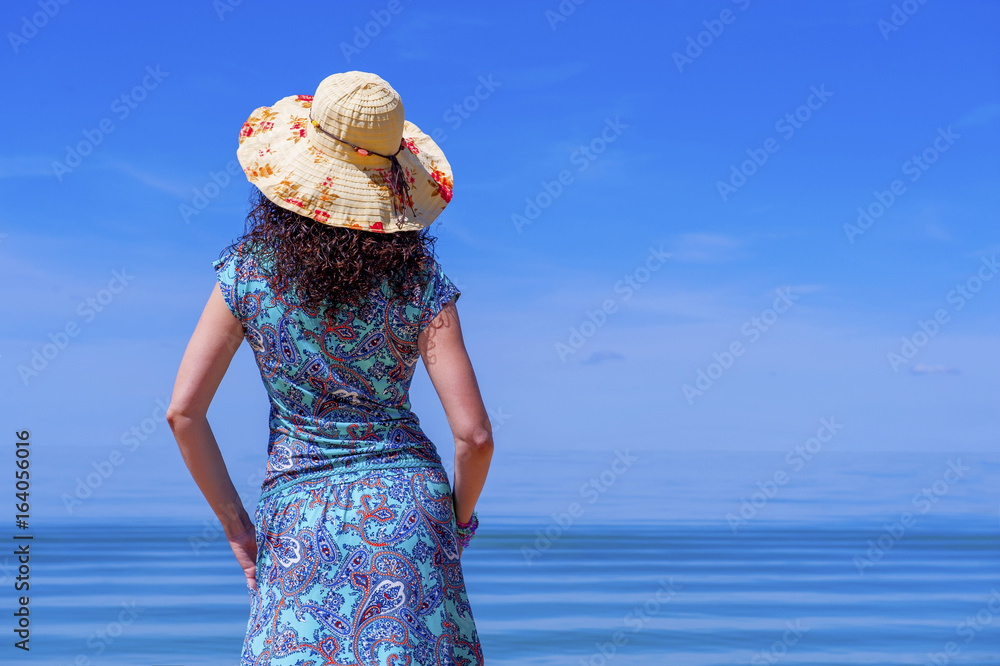 Beautiful Girl near the sea. Beautiful caucasian girl by the sea. Concept of the sea. Happy. Blue sky background. 