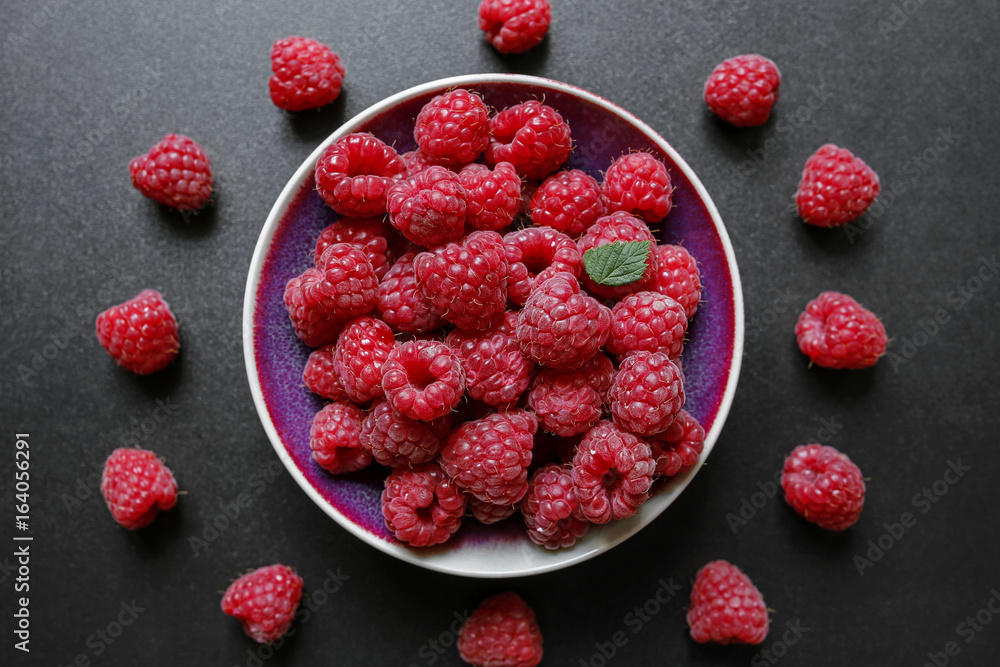 fresh raspberries in a bowl on black background fresh raspberries in a bowl on black background