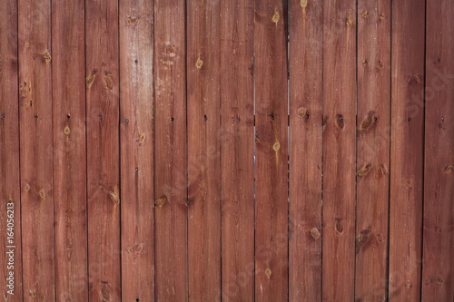 Brown fence with metallic crossbar