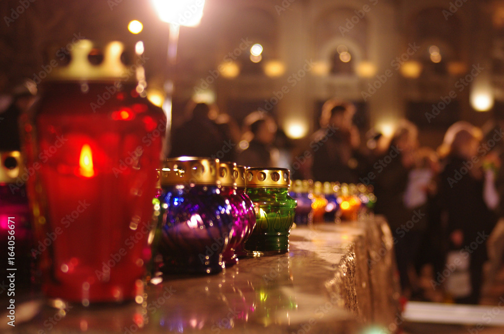 Colored candle lanterns on a stone pedestal Colored candle lanterns on a stone pedestal