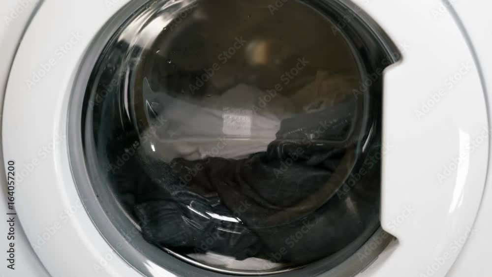 Washing machine is washing clothes Washing machine is washing clothes