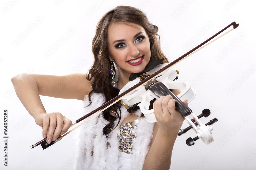 Girl violinist. Beautiful Caucasian girl. Violinist in show costume. On a white background. Vertical photo. Girl violinist. Beautiful Caucasian girl. Violinist in show costume. On a white background. Vertical photo.