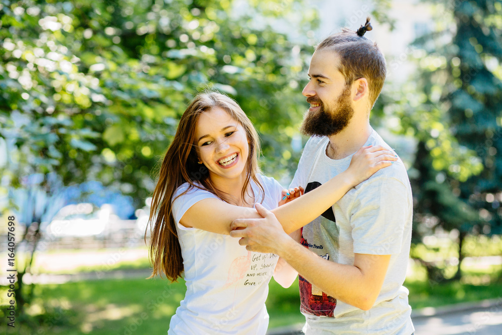 Beautiful bearded man biting the woman's cheek. The concept of tenderness and affection Beautiful bearded man biting the woman's cheek. The concept of tenderness and affection
