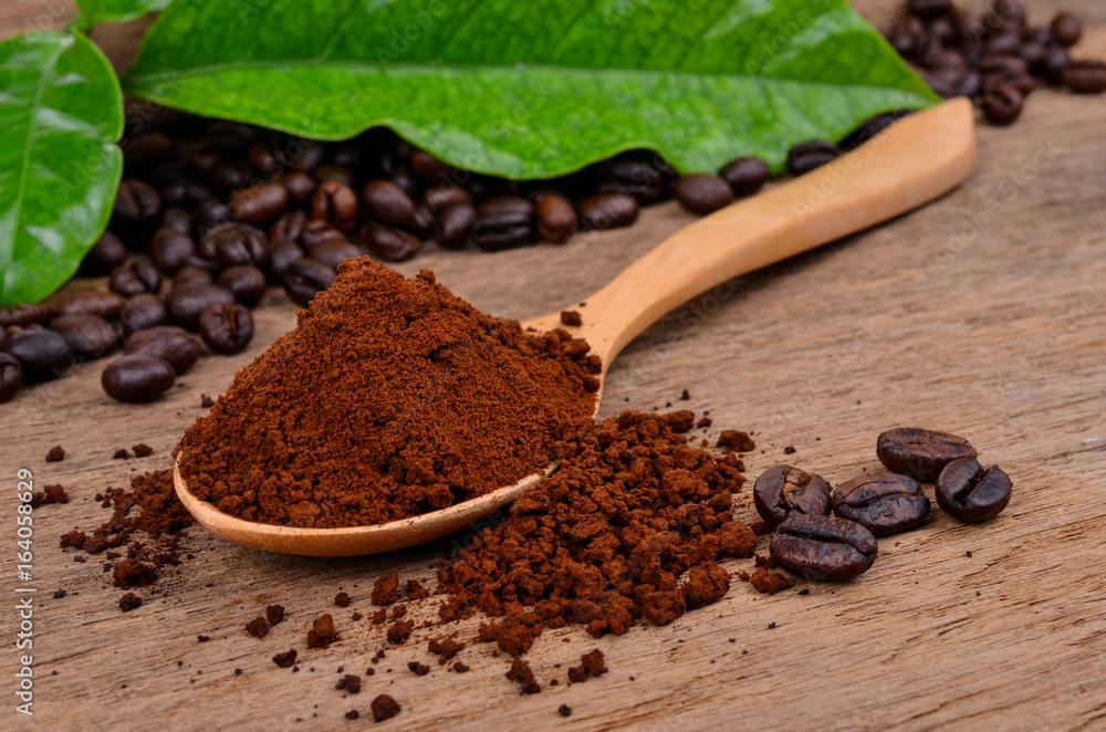 coffee beans and ground coffee on a wooden background coffee beans and ground coffee on a wooden background