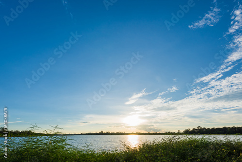 Fototapeta Naklejka Na Ścianę i Meble -  Beautiful sunset landscape with blue sky over lake