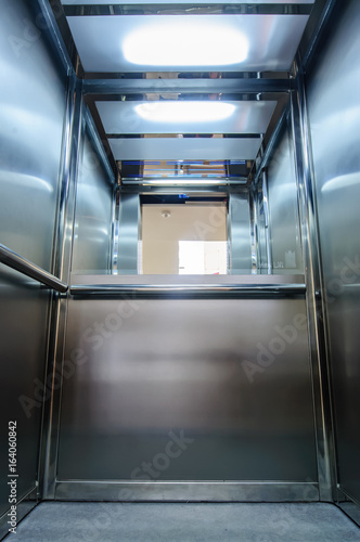 Elevator with new and modern cabin made of bright alloy and metal with modern elevator buttons