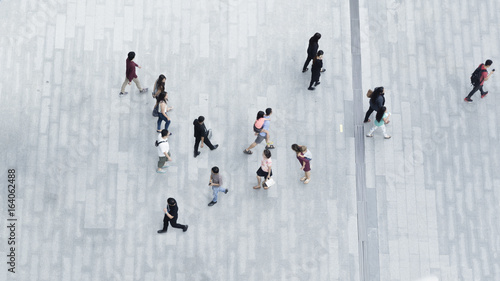 people walk on the pedestrian city street walkway on pavement concrete with the teenage young boy and girl and the group of fashion man and woman. (Aerial urban city photo)