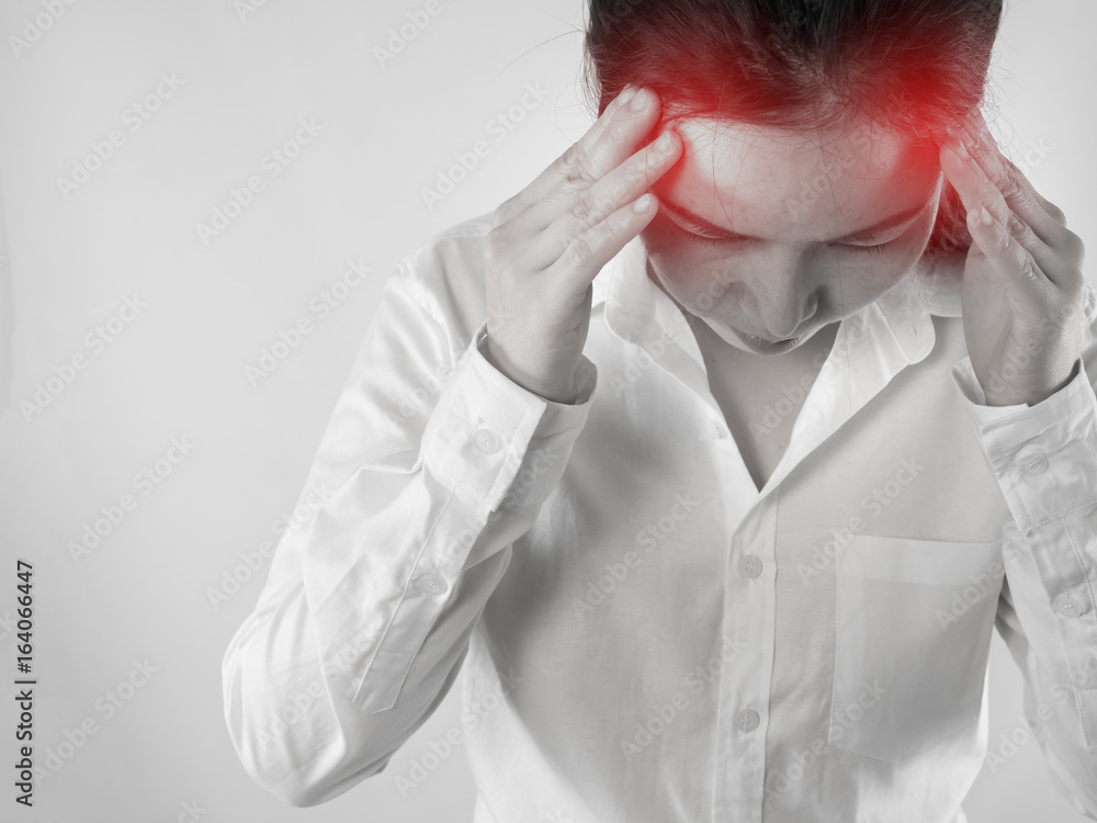 Young Asian woman touching head and having strong headache, concept of office worker health care lifestyle.