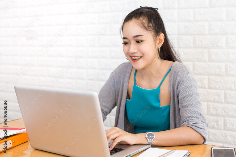 Asian woman using laptop with attractive smiling, Portrait Woman working concept, 20-30 year old. Asian woman using laptop with attractive smiling, Portrait Woman working concept, 20-30 year old.