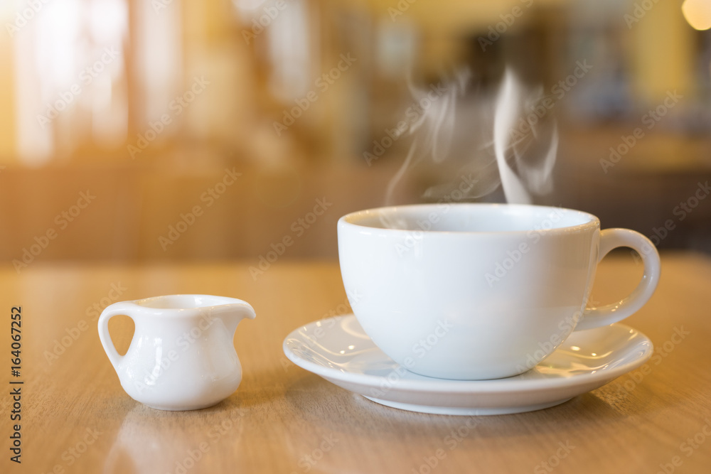 Fototapeta premium Cup of coffee and smoke on wooden floor
