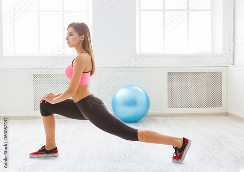 Fitness woman at stretching training indoors