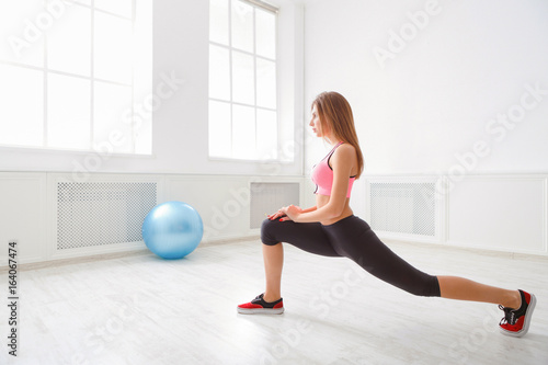 Fitness woman at stretching training indoors