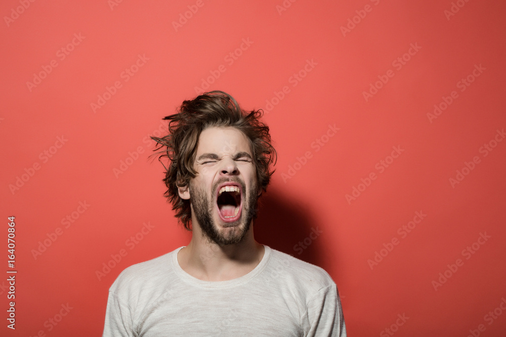 shouting or yawning man with long uncombed hair, morning, headache shouting or yawning man with long uncombed hair, morning, headache