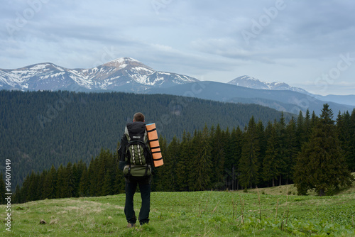 Tourist with a backpack in the mountains
 photo