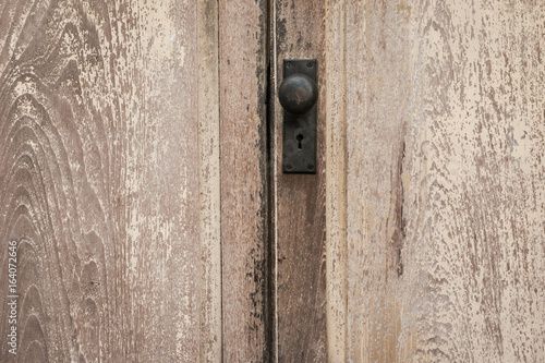 Rustic vintage door knob on antique door wood. Door knob and keyhole made of brass on the old wooden door. Door knob for background.