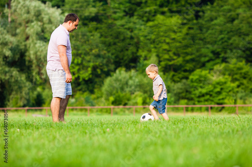 Father and son playing football